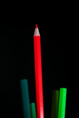 red color pencil on black background